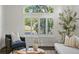 Living room with large window with shutter, hardwood floors, and comfortable seating at 12695 Wolff St, Broomfield, CO 80020