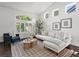 Bright and airy living room featuring large windows, hardwood floors, and stylish decor at 12695 Wolff St, Broomfield, CO 80020
