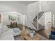 Bright living room with hardwood floors, white walls, and a staircase at 12695 Wolff St, Broomfield, CO 80020