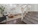 Bright living room featuring hardwood floors, a modern staircase, and tasteful decor at 12695 Wolff St, Broomfield, CO 80020