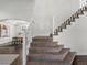 Carpeted staircase leading to dining room with natural light, ideal for a Gathering home at 12695 Wolff St, Broomfield, CO 80020