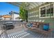 Cozy back deck with a pergola, grill, and swing seating, perfect for outdoor entertaining and relaxation at 15562 E 109Th Ave, Commerce City, CO 80022
