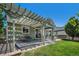 Spacious backyard featuring a covered deck with swing, patio seating, and lush green lawn for outdoor living at 15562 E 109Th Ave, Commerce City, CO 80022
