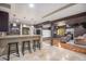 Spacious basement with tile flooring and a sleek bar area, perfect for entertaining guests and relaxation at 15562 E 109Th Ave, Commerce City, CO 80022