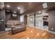 Finished basement featuring a cozy entertainment area with seating and a convenient wet bar for entertaining at 15562 E 109Th Ave, Commerce City, CO 80022