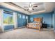 Bedroom with vaulted ceiling, large window providing natural light, and a four-poster wooden bed frame at 15562 E 109Th Ave, Commerce City, CO 80022