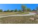 Scenic community park with lush green space, mature trees, and a playground for Gathering enjoyment at 15562 E 109Th Ave, Commerce City, CO 80022