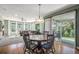 Dining area with a round table, chairs, and sliding door to the backyard patio at 15562 E 109Th Ave, Commerce City, CO 80022
