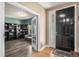 Inviting entryway featuring hardwood floors, a black front door with decorative glass, and a view into the office at 15562 E 109Th Ave, Commerce City, CO 80022