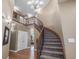 Grand foyer with a curved staircase, wood floors, and an elegant chandelier at 15562 E 109Th Ave, Commerce City, CO 80022