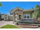 Charming front porch with stone supports and elegant landscaping in the front yard at 15562 E 109Th Ave, Commerce City, CO 80022