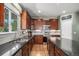 Well-lit kitchen with granite counters, stainless steel appliances, and ample cabinet space at 15562 E 109Th Ave, Commerce City, CO 80022
