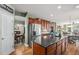 Modern kitchen with granite countertops, stainless steel appliances, and dark wood cabinets at 15562 E 109Th Ave, Commerce City, CO 80022