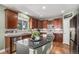 Spacious kitchen with dark wood cabinetry, stainless steel appliances, and a granite-topped island at 15562 E 109Th Ave, Commerce City, CO 80022