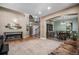 Open-concept living area with a fireplace, staircase, and dining room visible, creating an inviting space at 15562 E 109Th Ave, Commerce City, CO 80022