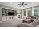Cozy living room with a fireplace, built-in shelving, and plush seating at 15562 E 109Th Ave, Commerce City, CO 80022