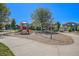 Community playground with play structure and slide, benches, and swings surrounded by well-maintained landscaping at 15562 E 109Th Ave, Commerce City, CO 80022