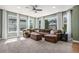Bright sun room with large windows, neutral decor, and comfortable seating area at 15562 E 109Th Ave, Commerce City, CO 80022