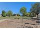 A public park swing set surrounded by lush greenery and neighborhood homes offers children a great activity at 15562 E 109Th Ave, Commerce City, CO 80022
