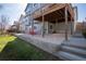 Backyard with a deck, a concrete patio, a grassy area, and stairs leading to the lawn at 7019 S Garrison St, Littleton, CO 80128