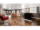Finished basement featuring a bar, dining table, additional seating, and stained concrete floors at 7019 S Garrison St, Littleton, CO 80128
