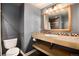 Bathroom featuring a large framed mirror, a single sink, and a toilet at 7019 S Garrison St, Littleton, CO 80128
