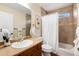 Bright bathroom featuring a shower/tub combo and a vanity with a single sink at 7019 S Garrison St, Littleton, CO 80128