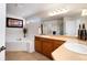 Bright bathroom features a large soaking tub and dual sinks, creating a spa-like retreat at 7019 S Garrison St, Littleton, CO 80128