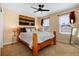 Serene bedroom with a wooden bed frame, ambient lighting, and two large windows at 7019 S Garrison St, Littleton, CO 80128