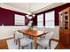 Elegant dining room with a classic chandelier, a wooden table and stylish chairs under natural light at 7019 S Garrison St, Littleton, CO 80128