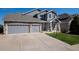 Charming two-story home featuring stone accents, a well-manicured lawn, and a spacious three-car garage at 7019 S Garrison St, Littleton, CO 80128
