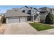 Charming two-story home featuring stone accents, a well-manicured lawn, and a spacious three-car garage at 7019 S Garrison St, Littleton, CO 80128