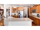 Spacious kitchen featuring stainless steel appliances, ample cabinetry, and a breakfast bar for casual dining at 7019 S Garrison St, Littleton, CO 80128