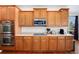 Well-equipped kitchen features stainless steel appliances and plenty of wooden cabinets and countertop space at 7019 S Garrison St, Littleton, CO 80128