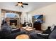 Inviting living room features a stone fireplace, hardwood floors, and comfortable seating for relaxation and entertainment at 7019 S Garrison St, Littleton, CO 80128