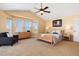 Bright main bedroom features a sitting area, large windows, and neutral decor at 7019 S Garrison St, Littleton, CO 80128