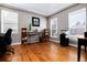 Bright home office with hardwood floors, multiple windows, and ample workspace, perfect for productivity at 7019 S Garrison St, Littleton, CO 80128