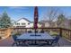 A spacious patio is furnished with a large table, chairs, and umbrella, offering a relaxing outdoor space at 7019 S Garrison St, Littleton, CO 80128