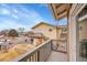 Balcony view of property featuring multiple units, exterior stairs, and neighborhood street at 2281 Coronado Pkwy # D, Denver, CO 80229