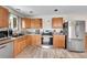 Functional kitchen features stainless steel appliances, wooden cabinetry, and ample counter space at 2281 Coronado Pkwy # D, Denver, CO 80229