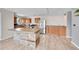 Spacious kitchen with stainless steel refrigerator, wooden cabinets, and island at 2281 Coronado Pkwy # D, Denver, CO 80229