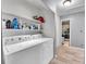 Functional laundry area with appliances and storage shelves and access to bathroom at 2281 Coronado Pkwy # D, Denver, CO 80229