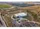Aerial view of modern school surrounded by beautiful landscape, walking paths, parking, and nearby neighborhood at 2853 Yosemite St, Denver, CO 80238