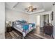Inviting bedroom with modern decor, ceiling fan, and dark wood floors, offering a cozy retreat at 2853 Yosemite St, Denver, CO 80238