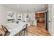 Open-concept layout with kitchen, dining area, and living room, showcasing hardwood floors throughout at 2853 Yosemite St, Denver, CO 80238