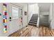 Welcoming foyer with hardwood floors, a stained glass front door, and a staircase at 2853 Yosemite St, Denver, CO 80238