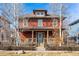 Charming two-story home with a front porch, mature trees, and a well-maintained lawn at 2853 Yosemite St, Denver, CO 80238