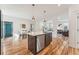 Bright kitchen boasts a center island with a sink, stainless steel dishwasher, and hardwood floors at 2853 Yosemite St, Denver, CO 80238