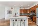 Spacious kitchen island with pendant lights, stainless steel appliances, and hardwood floors at 2853 Yosemite St, Denver, CO 80238