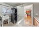 Convenient laundry room features a stackable washer and dryer, a sink, and storage shelves at 2853 Yosemite St, Denver, CO 80238
